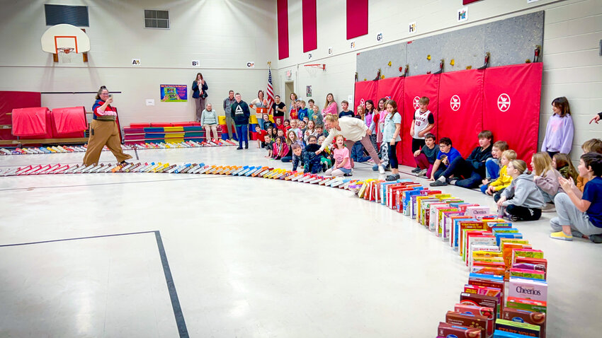 Sparta Montessori students enjoyed the kindhearted domino drop of 420 cereal boxes on March 4th, as their kindness generated breakfasts and high-decibel-level excitement for  all who attended. Herald photo by Jenny Moran.