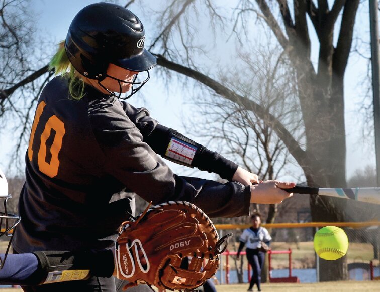 Sparta’s Kylie Burton makes contact with a pitch
during her first at-bat of the season Monday afternoon.