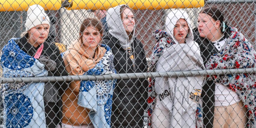 Tomah’s (from left to right) Haylee Pingel, Addison Brieske, Lauren Echelberg, Brooklyn Chapman and Marah Noth huddle together along the front side of the dugout during Tuesday’s game with Baraboo. Low temps and windy conditions made for a less-than-comfortable, but typical early-April softball experience for both Tomah and Baraboo.