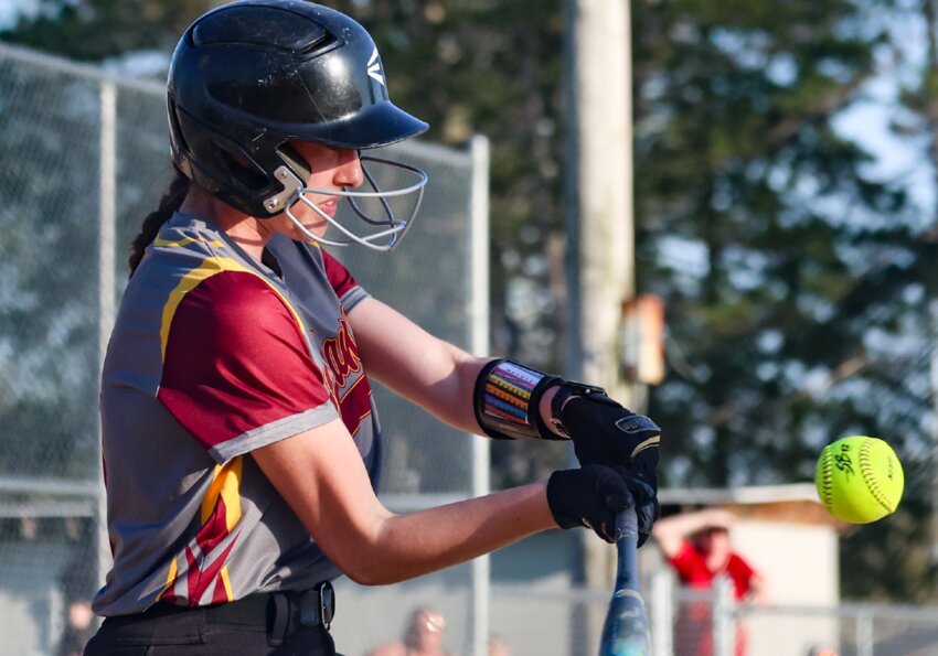 Sparta’s Avery Abbott puts the bat on the ball during the Spartans’ outing in the fifth inning of Tuesday’s game with Aquinas.