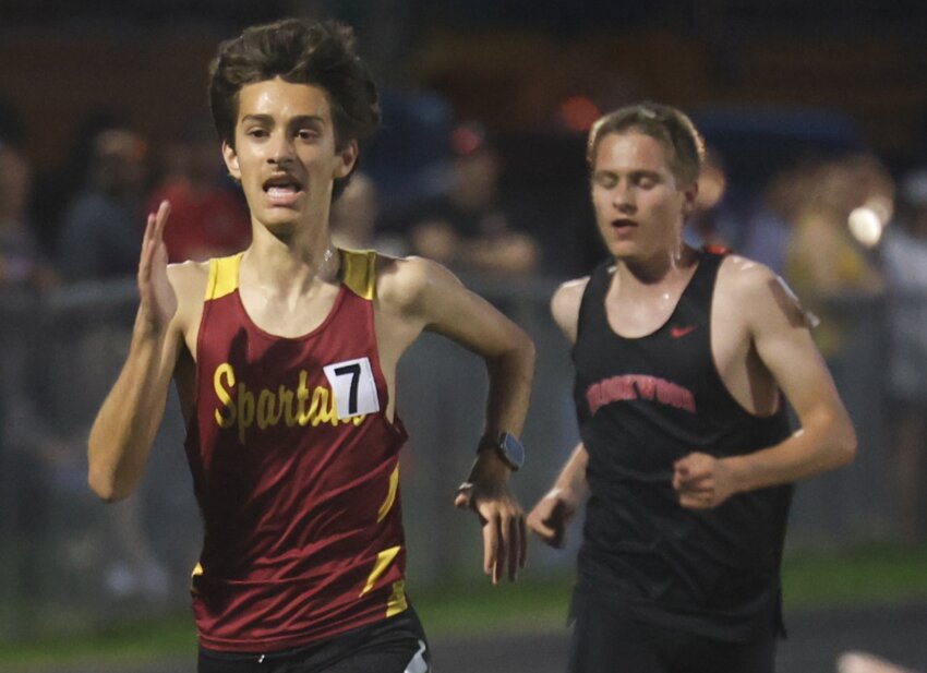 Sparta’s Braedyn Novak passes Brookwood’s August Rueckheim in the final 50 meters of the 3200 meter run to place second with a time of 10:47.31.