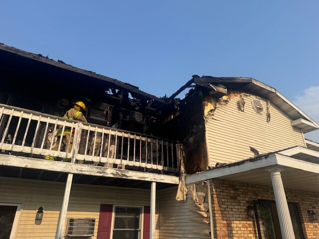 Fire officials inspect damage from a fire at an apartment complex on Terry Court in Sparta June 8.
