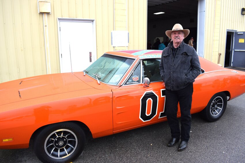 Tom Wopat poses in front of the General Lee, from his best-known role as Luke Duke, in the “Dukes of Hazzard” television show.