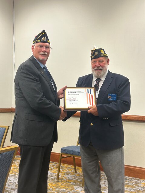 Monroe County Herald writer, John Gessner, receives a 1st place writers award from the National American Legion, for his previous article in the Monroe County Herald. The award was presented by Phil Green, Commander of the Wisconsin American Legion 7th District.