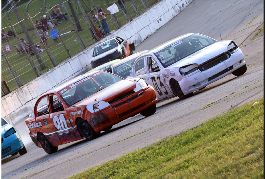 Curtis Hellickson (left) and Russel Allen (right)vie for position upon entering the final lap of the High School Racing Associaion heat race Friday night.