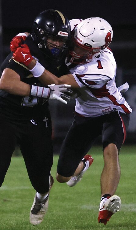 Bangor’s Landon Phillips attempts a tackle during the second half of Friday’s game at Luther. The Cardinals fell to 1-1 after taking a 28-0 loss.