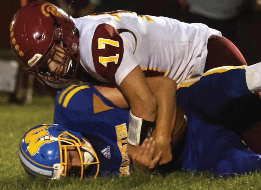 Sparta’s Nate Guns pushes Mauston’s Tyler Link into the ground after catching the quarterback in the backfield for a sack during the third quarter of Friday’s meeting between former South Central Conference rivals.