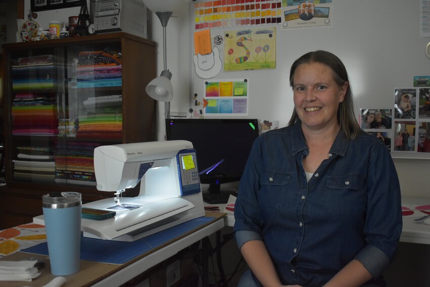 Rachelle Craig relocated to the Wonewoc area seventeen years ago, and has built her quilting business out of her home in rural Wonewoc. Pictured here, Craig poses in her quilting workshop.