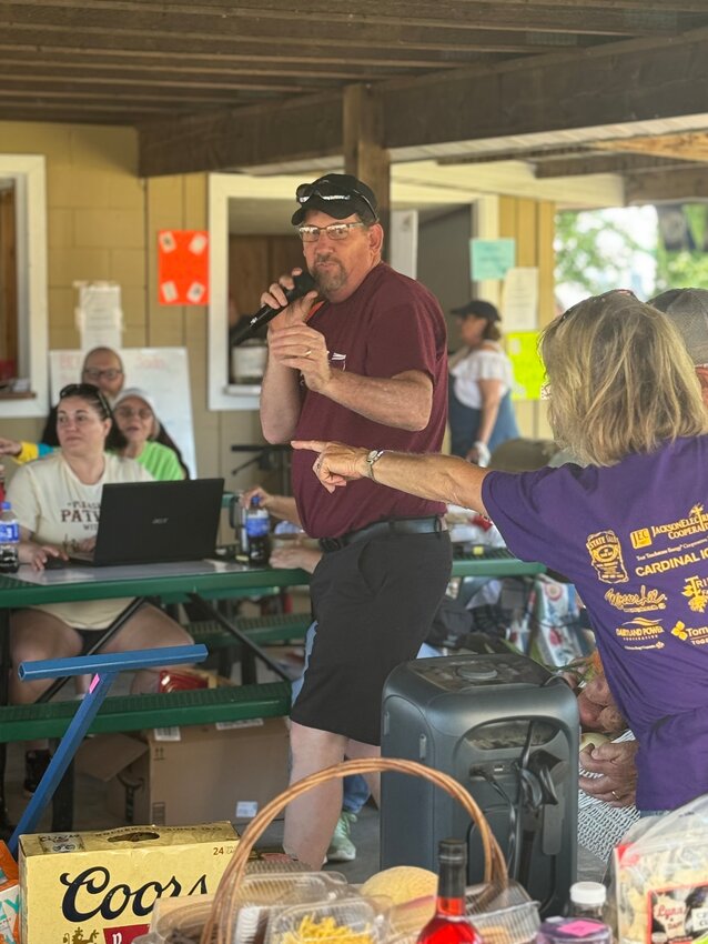 The live auction started at 3 p.m. on Saturday, with a pavilion filled with bidders. Pictured is auctioneer, Alex Goodman, and Sue Marcou, pointing out the bidders. The auction hauled in a total of $6,653.