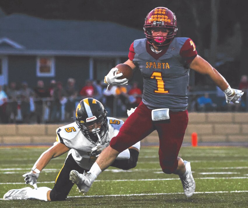 Sparta’s Camden McTaggart shakes off a tackle attempt by Tomah’s Cameron Finch and drives ahead to put SHS in a goal-to-go situation during the first quarter of Friday’s game. McTaggart finished with 100 yards and 3 TDs in the Spartans’ win.