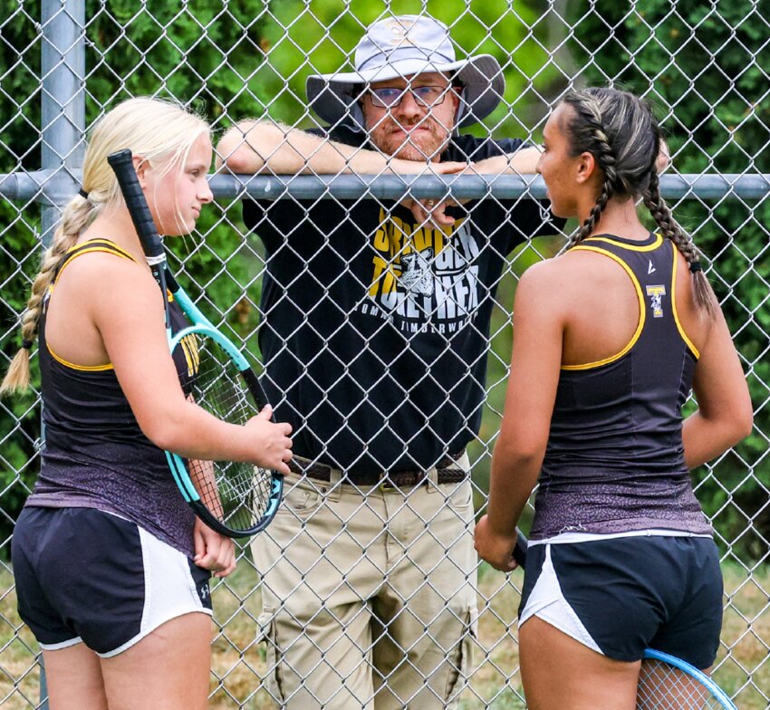 Tomah tennis head coach Ben Bannan talks with the second flight doubles team of Mackenzie Janz and Audrey Hoffman during Thursday’s match with Aquinas.