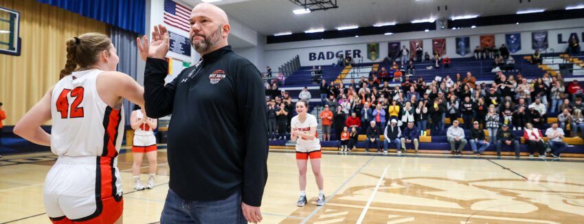 West Salem&rsquo;s Megan Johnson is greeted by coach Mike Malott while taking the court ahead of Saturday&rsquo;s Division 2 sectional final in Baraboo. Johnson and company played Madison Edgewood for a chance to go to state. Edgewood won 67-42 to end the Panthers&rsquo; season and prevent a third-straight WIAA state tournament appearance.