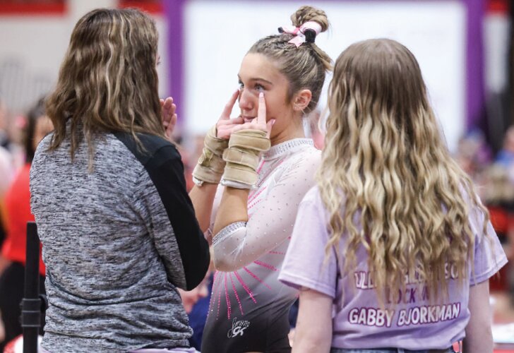 Sparta’s Lilly Gilbertson shares a tearful moment with coach Kassey Brooks after her last vault at the WIAA state meet on March 8.