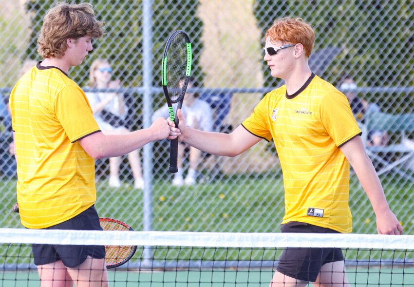 Tomah’s Brodie Robertson (left) and Boe Rewey (right) celebrate a successful rally during Tuesday’s match with Aquinas’ Patrick Gunderson and Ezra Barna. The Tomah doubles team held on for a 6-3, 6-2 win.