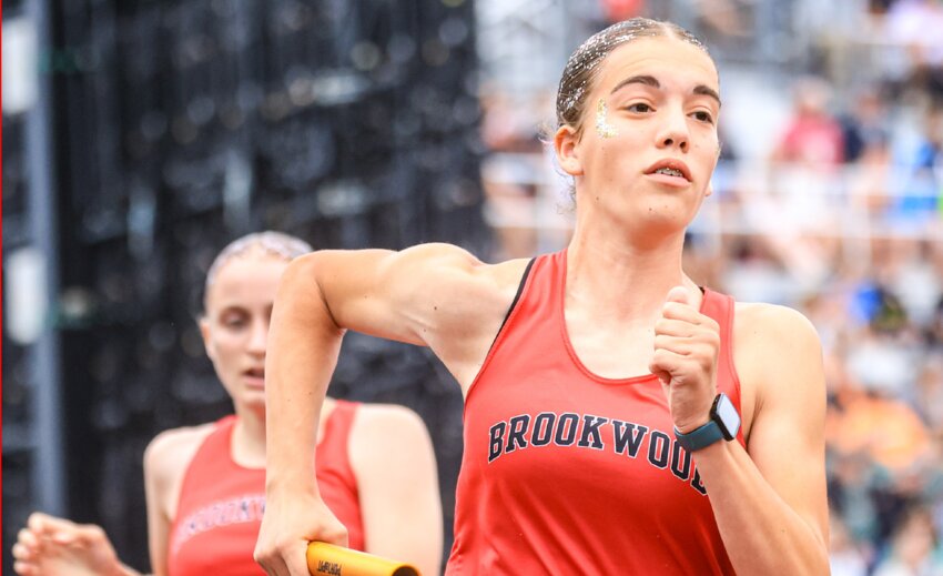 Brookwood&rsquo;s Miranda Arndt surges ahead after taking the baton from Kinsley Holmquist to start the third leg of the 800 meter relay. Brookwood finished 10th in prelims and 10th in the finals at the WIAA state track meet.