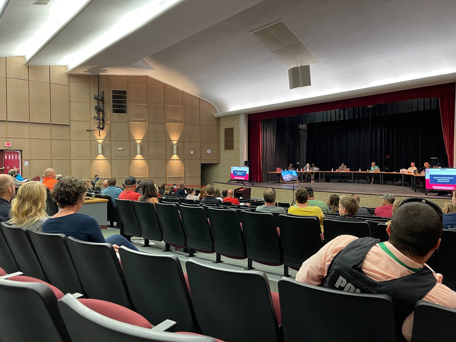 The special meeting was moved to the high school auditorium to accommodate a larger than usual crowd.