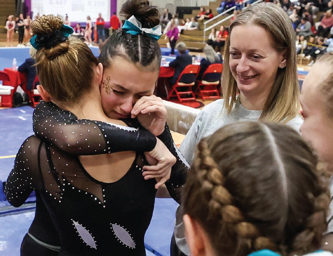 West Salem’s Hailey Ives shares a tearful embrace with teammate Olivia Maki
after her final performance on beam during the WIAA state gymnastics meet
on March 7 in Wisconsin Rapids.