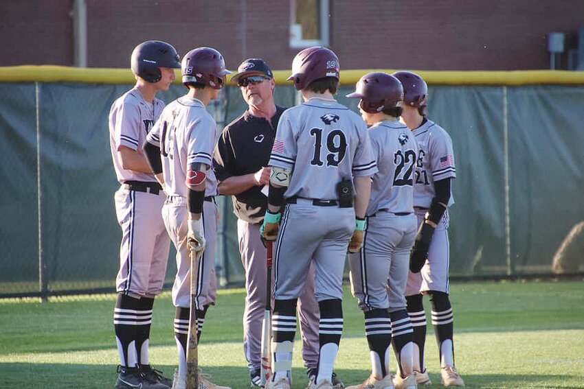 Huntsville Eagles head baseball coach Greg Harris confers with his team during a game in the 2024 season. Harris has announced he is retiring after eight years with the Huntsville School District.