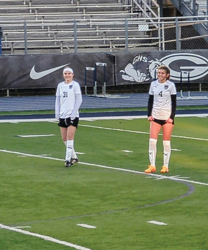 Huntsville girls soccer players freshman Lainey Spurlock (left) and junior Emaline Henry smile during a break in the action. The Lady Eagles lost 7-0 to Dardanelle on Thursday.