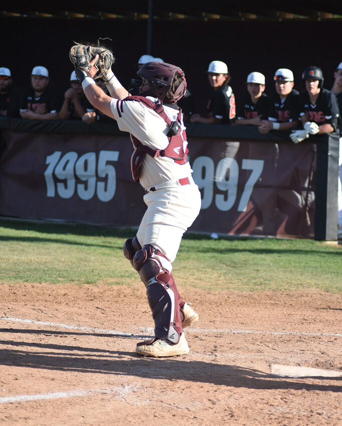Huntsville baseball senior catcher Kase Evans snags a ball.