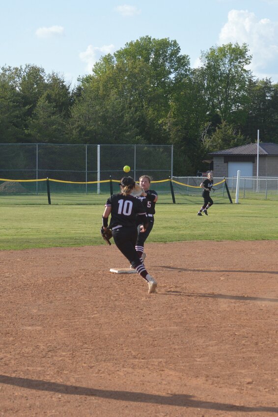 Huntsville freshman shortstop Laken Ledbetter tosses the ball to senior Gabby Thompson to record a force out at second base. The Lady Eagles defeated Green Forest, 21-11, on April 28, but were eliminated by host Gravette, 12-1, in the district softball tournament.