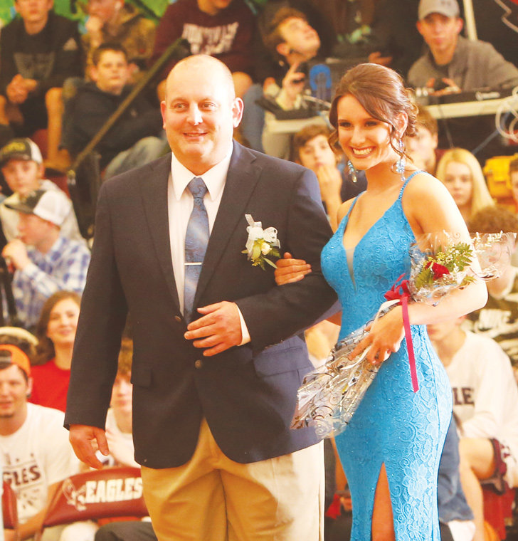 Junior Shelby Cook escorted by her father, John Cook.