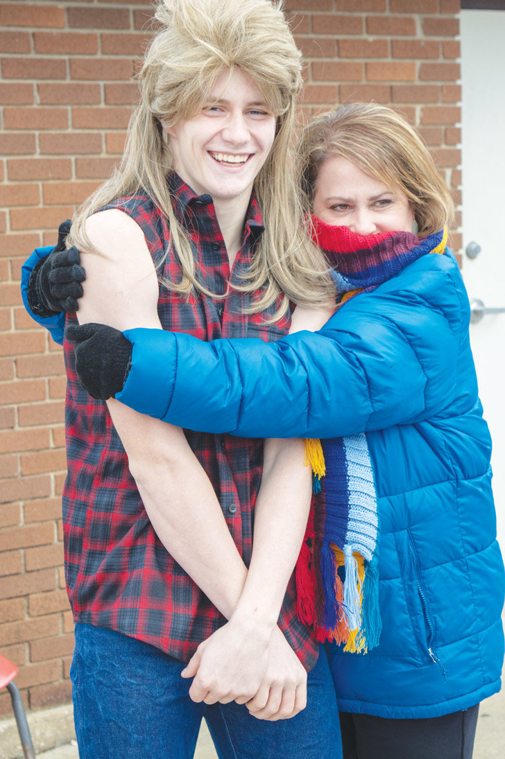A cold Tucker Bradley gets a hug from HHS Principal Roxanne Enix.