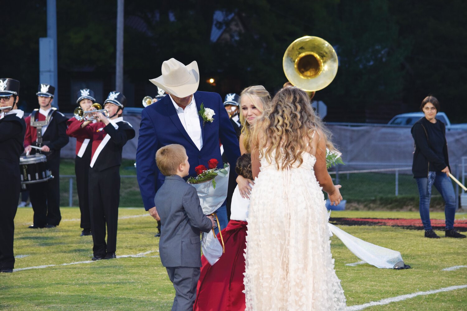 Returning 2022 Homecoming Queen, Savannah Villines, crowned Faith, with junior escorts Clayton Comer and Mallorie Thomas looking on.