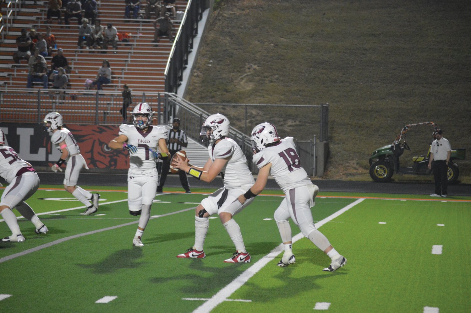 Huntsville junior Zack Cousins prepares to take a handoff from Marcus Shepherd while running a jet sweep.