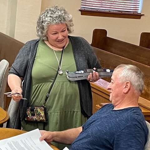 Newton County Library Director Kenya Windel offers a pair of solar eclipse glasses to Newton County Justice of the Peace Richard Campbell prior to the start of Monday night's quorum court meeting. The library has a large supply of the protective eyewear available free to the public. The Great American Solar Eclipse will occur on Monday, April 8. Most of Newton County is in the eclipse path of totality. Solar eclipse glasses need to be worn in order to safely view the eclipse before and after totality. Exposing your eyes to the sun without proper eye protection during a solar eclipse can cause “eclipse blindness” or retinal burns, also known as solar retinopathy. This exposure to the light can cause damage or even destroy cells in the retina (the back of the eye) that transmit what you see to the brain.