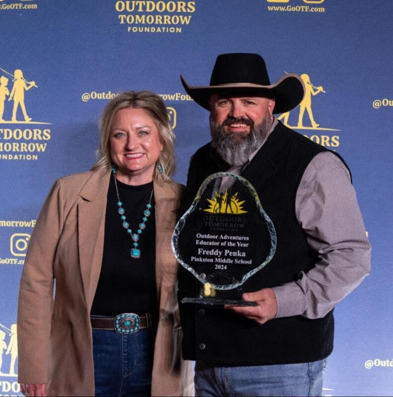 Tammy and Freddy Penka with the Outdoors Tomorrow Foundation’s Educator of the Year Award.