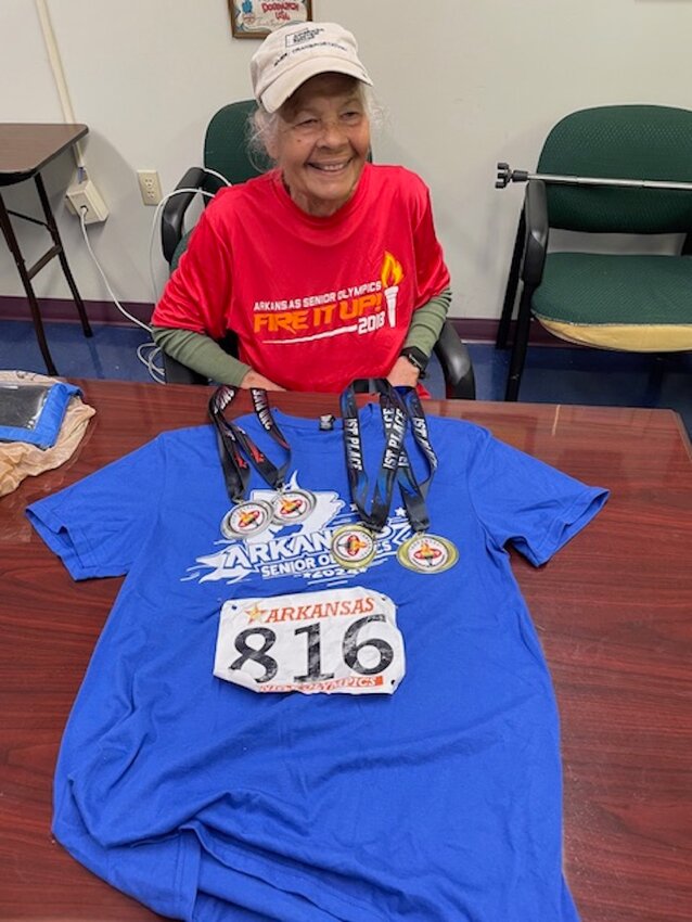 Hannah Ashworth, 82, of Parthenon, competed in the 2024 Arkansas Senior Olympics held April 27 in Fayetteville. She won two gold and two silver medals in track events. She is pictured showing off the medals along with the running shirt she wore in the events.