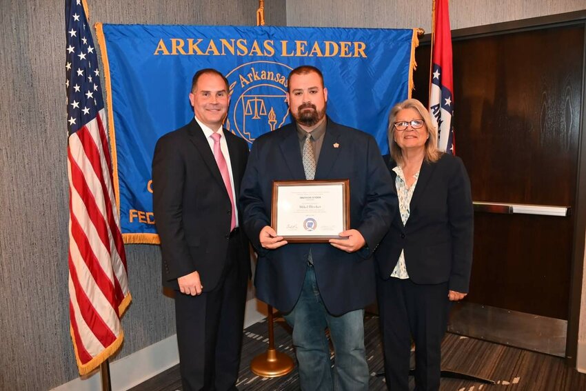 Newton County Chief Deputy Mike Blocker receives his ARKANSAS LEADER graduation certificate from Colonel Mike Hagar (left), Secretary of the Arkansas Department of Public Safety and Director of the Arkansas State Police and Dr. Cherly May (right), Director of the University of Arkansas Criminal Justice Institute.