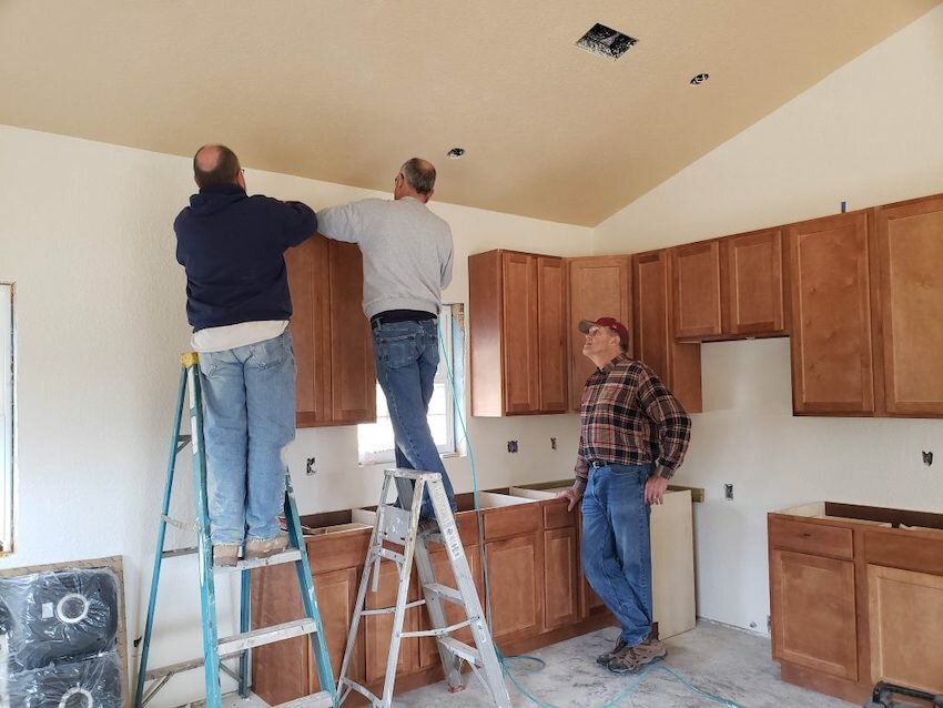 A team from FUMC Rogers in the Northwest District install cabinets in a rebuilt home that was destroyed in the April 2018 Crawford County Tornado.
