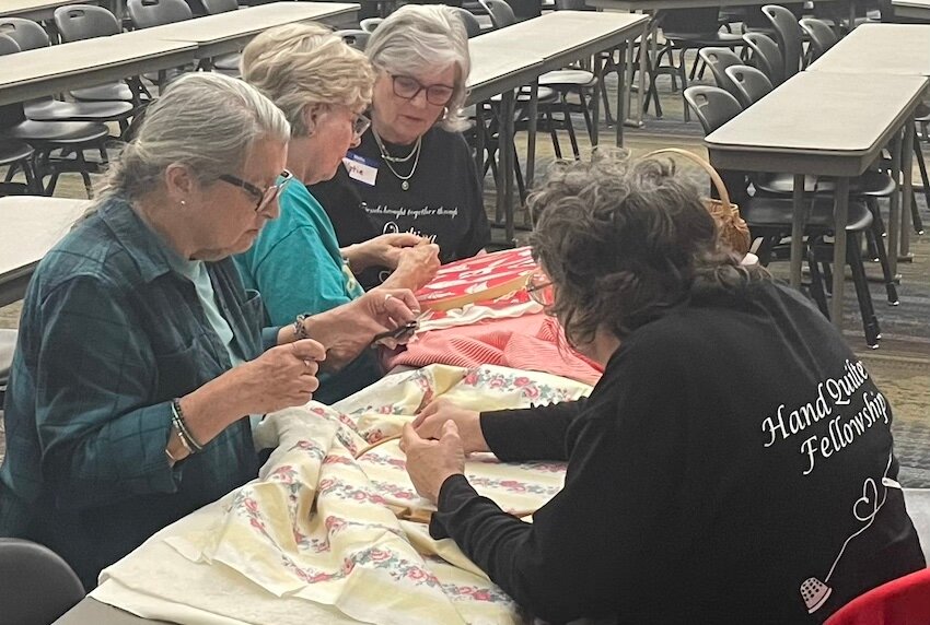 Participants in the Northwest Arkansas Quilting Workshop work together to put the pieces together of a club project. The last workshop will be Thursday, May 1, at Signature Bank Community Room in downtown Harrison.