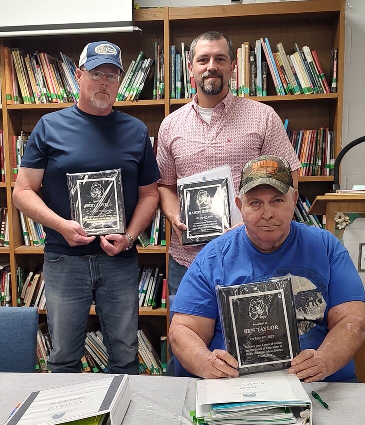 Gary Lovell (standing, left) Randy Brumley and Ben Taylor received plaques from Superintendent Lewis to show his appreciation for their service on the OMSD School Board