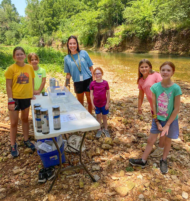 Delaney Stephens, an intern at the J.B. and Johnelle Hunt Family Ozark Highlands Nature Center working with students to identify insects, crustaceans and other species during her internship last summer.
