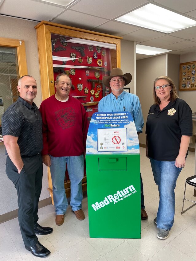 Observe Arkansas Take Back on Saturday Oct. 26 by dropping off your old and unwanted medicines in the Drug Take Back disposal box located in the lobby of the Newton County Law Enforcement Center in Jasper. Pictured with the box are from left, Jasper Mayor Mike Thomas, Newton County Partners in Prevention Coalition Chair Jeff Dezort; Newton County Sheriff Glenn Wheeler and Newton County Jail Administrator Charity Richardson.