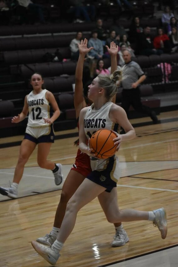 JEFF BRASEL/STAFF   Taelor Tomlinson of Berryville drives to the basket for a shot. The Lady Bobcats started Class 4A State Basketball Tournament play on Thursday in Magnolia. They lost to Arkadelphia in the contest.