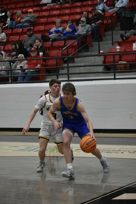 JEFF BRASEL/STAFF   Kingston guard Caleb Parker drives the baseline on Thursday in Magazine in the Class 1A Region 1 Basketball Tournament. Parker and the Yellow Jackets fell to Mulberry in the contest.