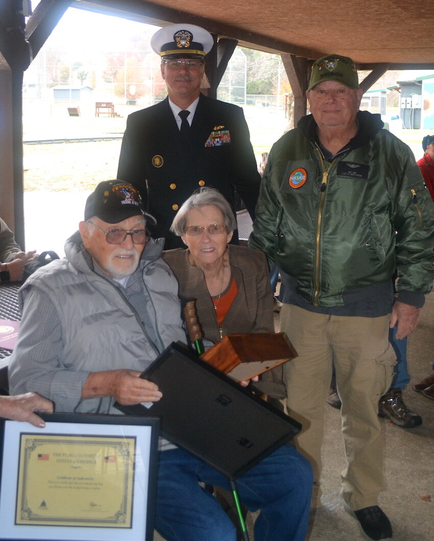 Certificates and flag presented to Dennis Brasel.