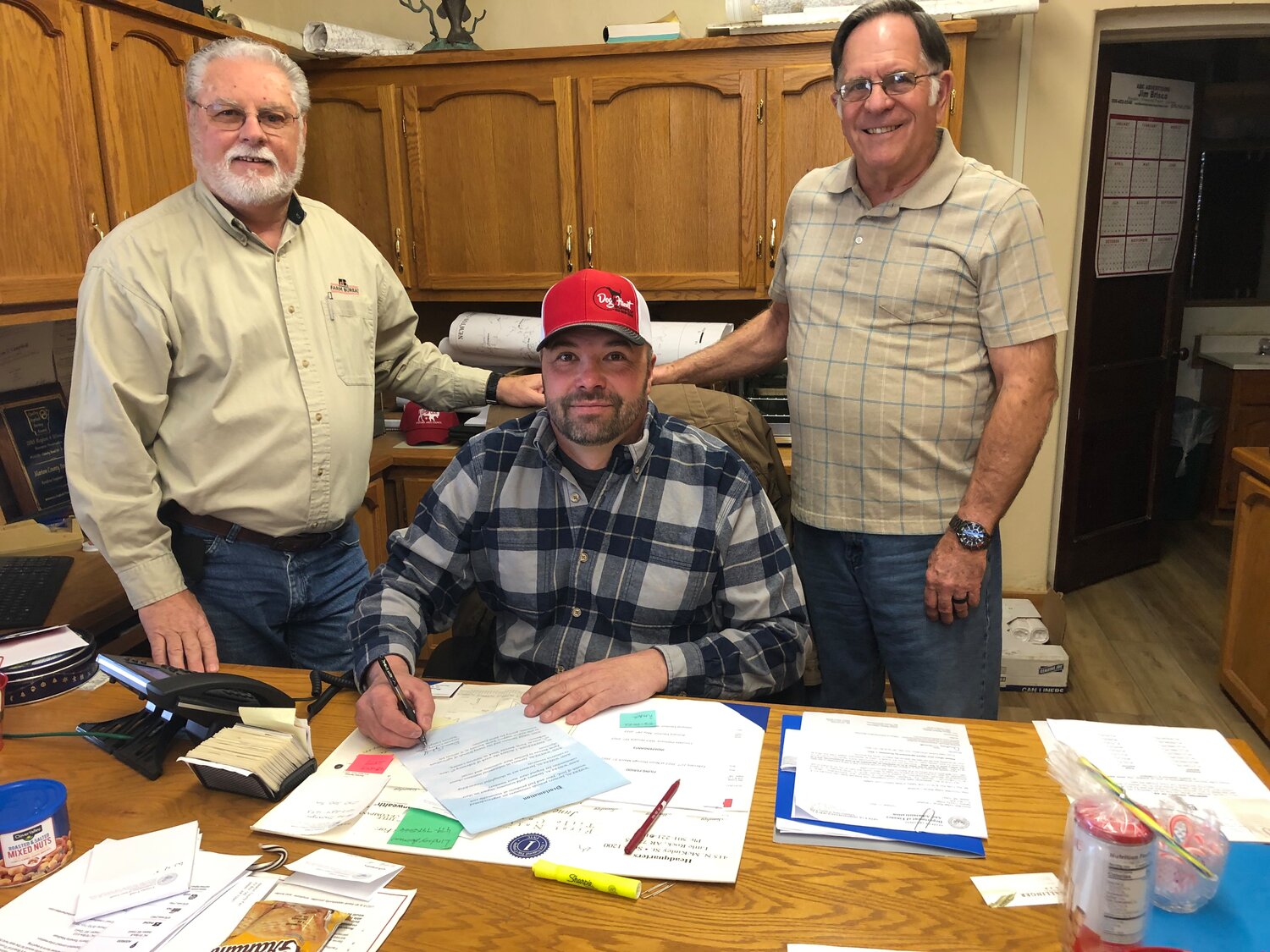 Newton County Judge Warren Campbell signed a proclamation making Feb. 5-9 Farm Bureau Week for Newton County. At the signing was Board Secretary Stan Taylor, left, and Board Member Larry Ochs.