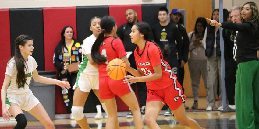 David Sowders/Arizona Silver Belt The Lady Braves' Ellysia Cutter (23) looks to drive past Lady Vandals defender Leeyah Goss (2) during a Feb. 3, 2024 Miami-San Carlos girls' basketball game. Both teams have reached the Division 2A championship semifinals.