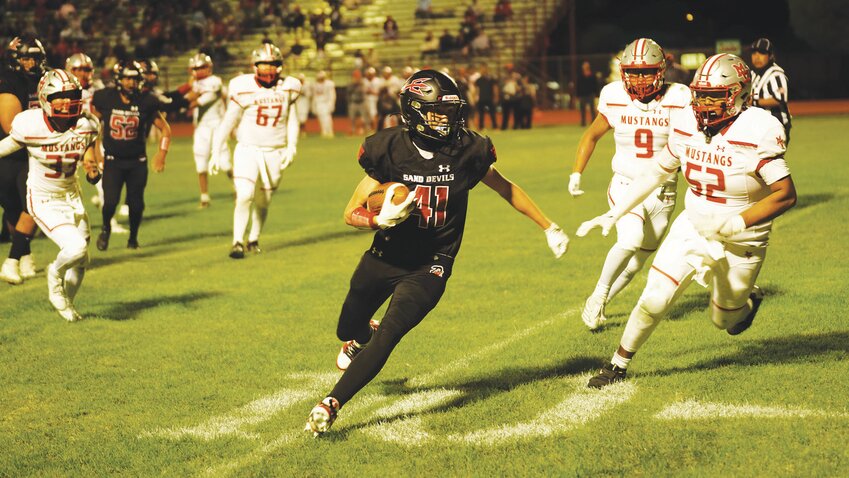 After a reception, Deegan Sparks (41} dashes his way through a seam of Mustang defenders. Sparks was the Sand Devils Offensive Player of the Week with 150 yards receiving and two touchdowns.