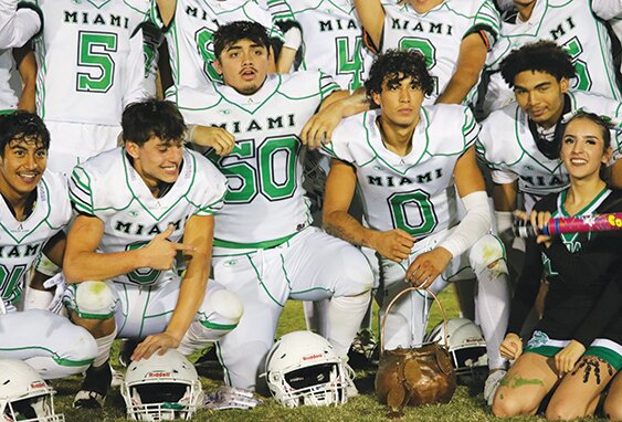 Miami High School football players and cheerleaders gather around the Copper Kettle, which will stay in Miami another year after the Vandals’ Friday night victory against Globe High School.