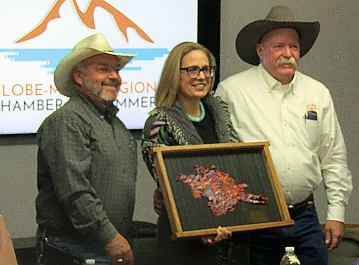 David Sowders/Arizona Silver Belt During her visit to Globe on Friday, Senator Kyrsten Sinema (I–Az.) met with community leaders from Gila and Pinal Counties to hear their concerns. Pictured, from left, are Gila County Supervisor Tim Humphrey, Senator Sinema and Gila County Supervisor Woody Cline, who presented her with a framed copper splash in appreciation of her aid with the Pleasant Valley Veterans Retreat project.