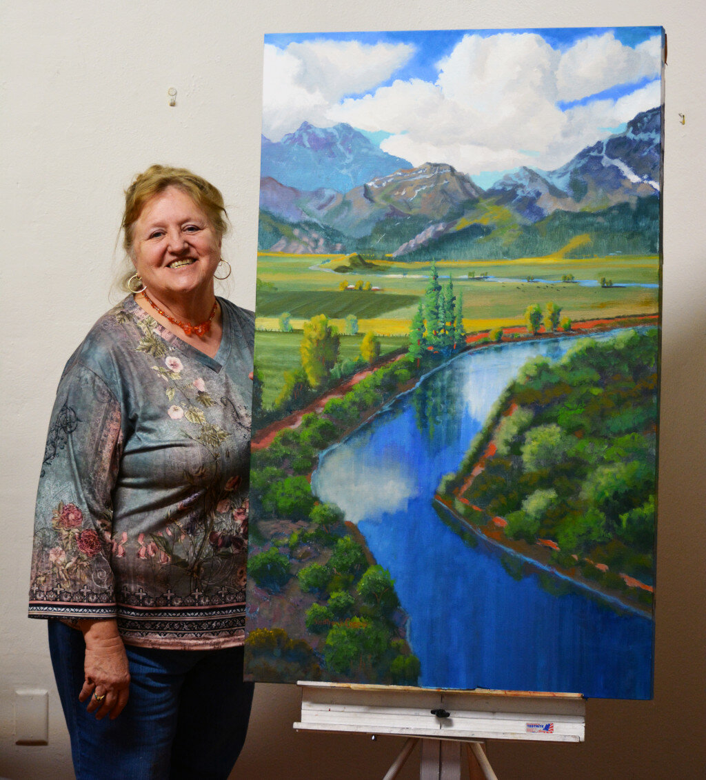 Douglas Long/Arizona Silver Belt
Heather Coen poses with her painting “Flow of Life.”