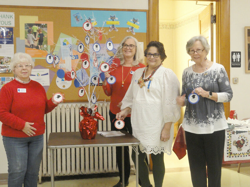 Left to right, Margaret Carr, Ruth Meinhardt, Donna Jungnickel, and Lonnie Schaefer add patriot ornaments to Fort du Rocher's patriot tree. (Photo contributed)
