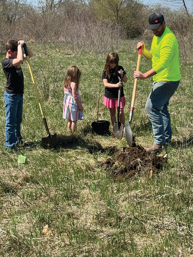 Each member of the Gregg family takes their turn digging holes to plant trees at Lake Kakusha thanks to a grant allowing 25 new trees on the Mendota property. The Gregg family, left to right, Logan, Piper, Katie, and David, are from LaMoille and are part of the LaSalle County Homesteaders 4-H Club.