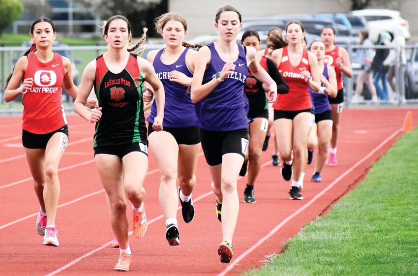Sophomores Annaliese Koziol and Mary Chadwick race near the front of the pack during the 800-meter run.